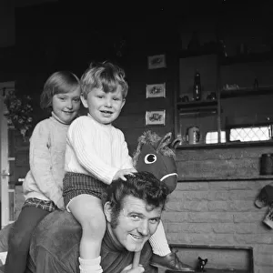 Liverpool goalkeeper Tommy Lawrence playing with his young son Stephen