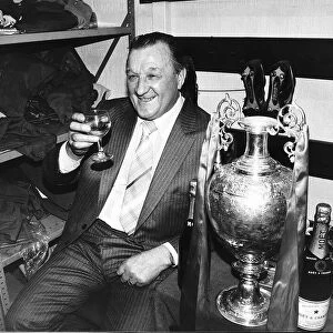 Liverpool manager Bob Paisley celebrates with a glass of champagne in the dressing room