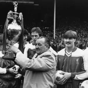 Liverpool manager proudly padres the League Championship trophy to the Liverpool Liverpool manager proudly padres the League Championship trophy to the Liverpool