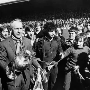 Liverpool manager Bill Shankly celebrates with the League Championship trophy as his side Liverpool manager Bill Shankly celebrates with the League Championship trophy as his side