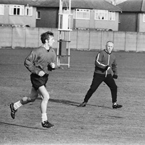 Liverpool manager Bill Shankly keeps a close eye on Liverpool forward Peter Thompson as