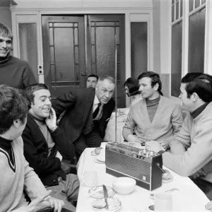 Liverpool manager Bill Shankly listening to the FA Cup draw with some of his players over