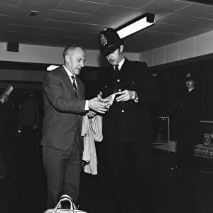 Liverpool manager Bill Shankly signs an autograph for a Manchester policeman as his team