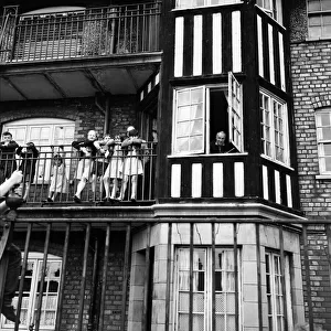 Liverpool mananer Bill Shankly watches a game of Street football from a flat above Eldon