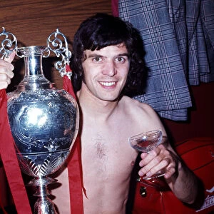 Liverpool player Peter Cormack celebrates winning the League Championship with the trophy