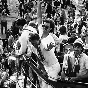 Liverpool players proudly show off the European Cup trophy to thousands of fans who lined