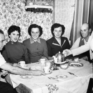 Liverpool full back Ronnie Moran has a cup of tea poured for him bis mother at home Liverpool full back Ronnie Moran has a cup of tea poured for him bis mother at home