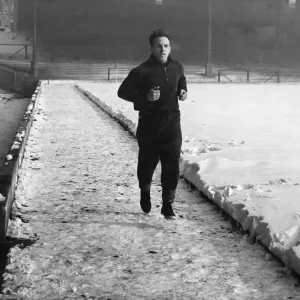 Liverpool full back Ronnie Moran putting in a spot of training despite conditions Liverpool full back Ronnie Moran putting in a spot of training despite conditions