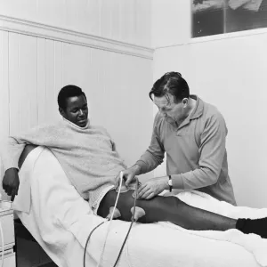 Liverpool team trainer Bob Paisley tends to William Louther