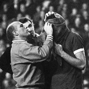 Liverpool trainer Ronnie Moran attends to John Toshack who has received a nasty cut