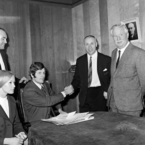 Liverpools new signing John Toshack from Cardiff City signs his contract accompanied