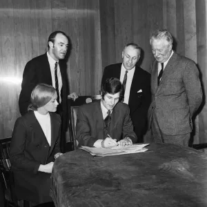 Liverpools new signing John Toshack from Cardiff City signs his contract accompanied Liverpools new signing John Toshack from Cardiff City signs his contract accompanied