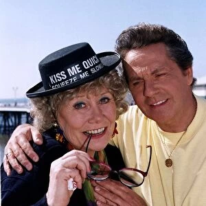 Liz Dawn actress wearing a Kiss Me Quick hat with David Ross