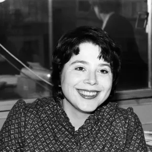 Liz Forgan in her office, print of a woman sitting at a desk