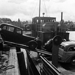 Loading a car onto a ferry steamer at the Quay at Oban. Oban is a resort town within