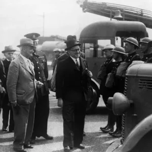A local mayor inspecting an auxiliary fire fighting crew. Circa 1940 A local mayor inspecting an auxiliary fire fighting crew. Circa 1940