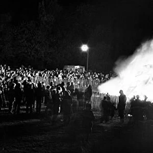 Local residents gather around the bonfire at Clairville Common