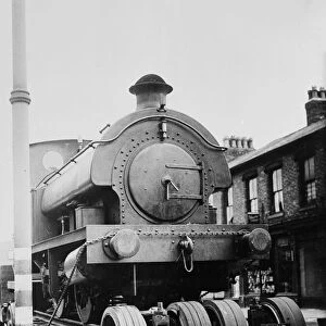 A locomotive train is drawn through the streets of Stretford on the way to the repair