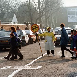 Lollipop lady Susan Hall escorts children across Crescent Road, Worcester Street Crossing