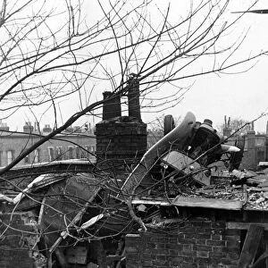 A London Fire Service auxiliary van thrown on to a roof by a falling bomb during