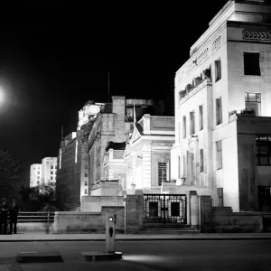 London by night two policemen stand on a bridge on the Embankment with Shellmex