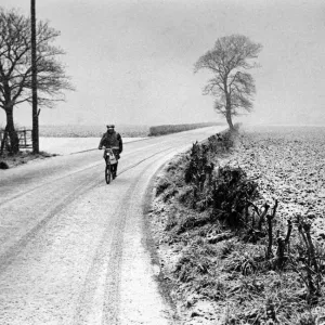 A lone cyclist pedals through the blizzard at Aughton, Lancashire. 26th March 1975 A lone cyclist pedals through the blizzard at Aughton, Lancashire. 26th March 1975