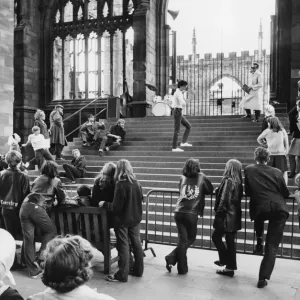 Print of girls and boys watching a rehearsal on Coventry Cathedral steps Print of girls and boys watching a rehearsal on Coventry Cathedral steps