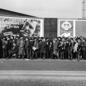 A long line of football fams queuing up to enter the stadium before a match in the North A long line of football fams queuing up to enter the stadium before a match in the North