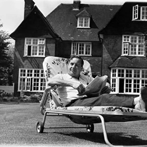 Lord Willis was wearing a red check summer shirt, reclining in a garden chair on a lush