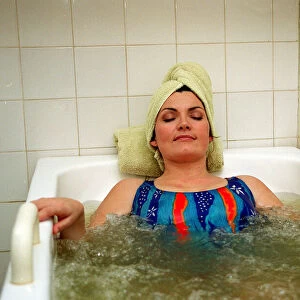 Lorraine Kelly Beauty treatment lying in bath wearing head towel