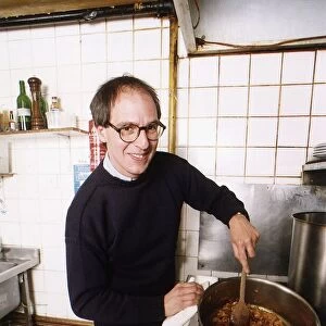 Loyd Grossman TV Presenter of Master Chef in his own kitchen trying out his own cooking