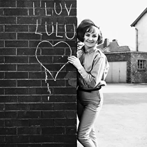 LuLu pop singer stands besides wall. 16th May 1964