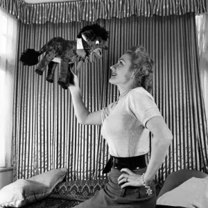 Lynne Breton. Woman with stuffed toy donkey. October 1952 C4870-002