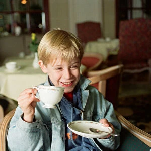 Macaulay Culkin sips his tea as he toasts his membership of he million-dollar-a movie