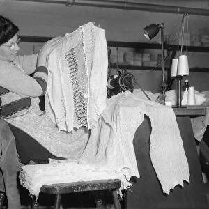 Machinist assembles a lace cardigan at The Shawl Factory of GH Hurt