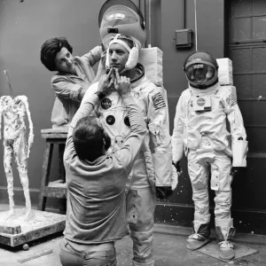 Madame Tussauds staff put the finishing touches to waxwork models of astronauts Neil