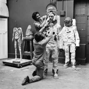 Madame Tussauds staff put the finishing touches to waxwork models of astronauts Neil