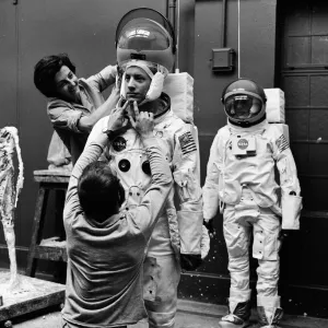 Madame Tussauds staff put the finishing touches to waxwork models of astronauts Neil