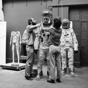 Madame Tussauds staff put the finishing touches to waxwork models of astronauts Neil