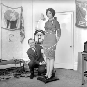 Magician Bernard Hughes performing rope trick with female assistant. April 1965 A1116b Magician Bernard Hughes performing rope trick with female assistant. April 1965 A1116b