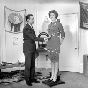 Magician Bernard Hughes performing rope trick with female assistant Magician Bernard Hughes performing rope trick with female assistant
