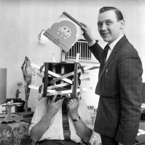 Magician sawing man in half also performing the swords in a box trick Magician sawing man in half also performing the swords in a box trick