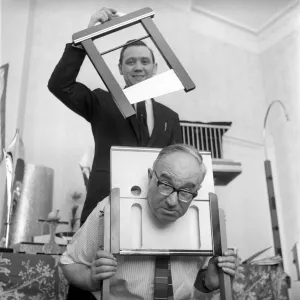 Magician sawing man in half also performing the swords in a box trick Magician sawing man in half also performing the swords in a box trick