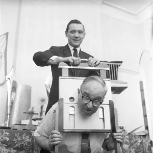 Magician sawing man in half also performing the swords in a box trick Magician sawing man in half also performing the swords in a box trick