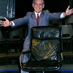 Magnus Magnusson mastermind presenter TV presenter arms out behing chair