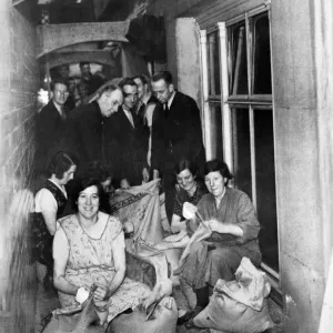 Making sandbags in the shelter - Women are making and men filling sandbags in Making sandbags in the shelter - Women are making and men filling sandbags in