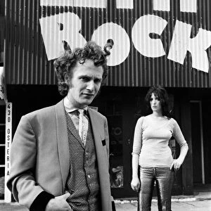 Malcolm McLaren dressed as a teddy boy outside his shop "Let it Rock"