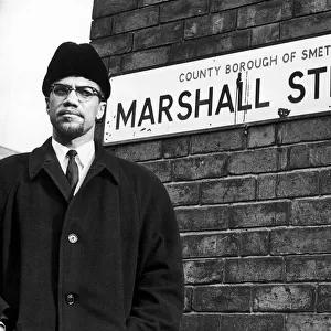 Malcolm X African-American Muslim minister and human rights activist poses beside