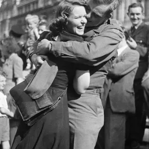 A male and female soldier embrace on hearing the news that Japan has surrenders in World A male and female soldier embrace on hearing the news that Japan has surrenders in World
