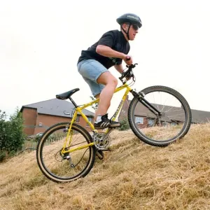 A man on his Diablo mountain bike climbing hills A man on his Diablo mountain bike climbing hills